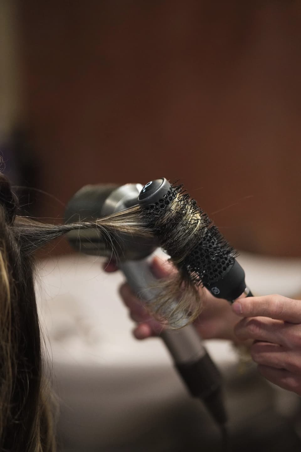 A round-brush blow-dry in motion.